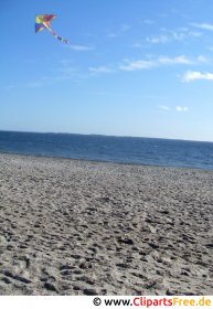 Flying a kite on the beach photo free